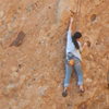 Climber working the wonderful pockets on the "Green Mile."