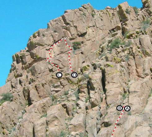 Looking to the North from the West End (Fin/Elverum Cove) of Southern Comfort Wall. <br>
<br>
Only top of C & D are visible.  They are in a slot on the top of the ridge. <br>
<br>
A. Done For Already<br>
B. Karma<br>
C. The Goat Path<br>
D. Three Pump Chump