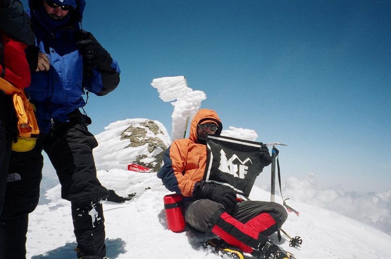 The summit of Mt. Elbrus with a banner thanking my local REI for the support.