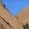 A climber rappelling off "Cracker Jacks."