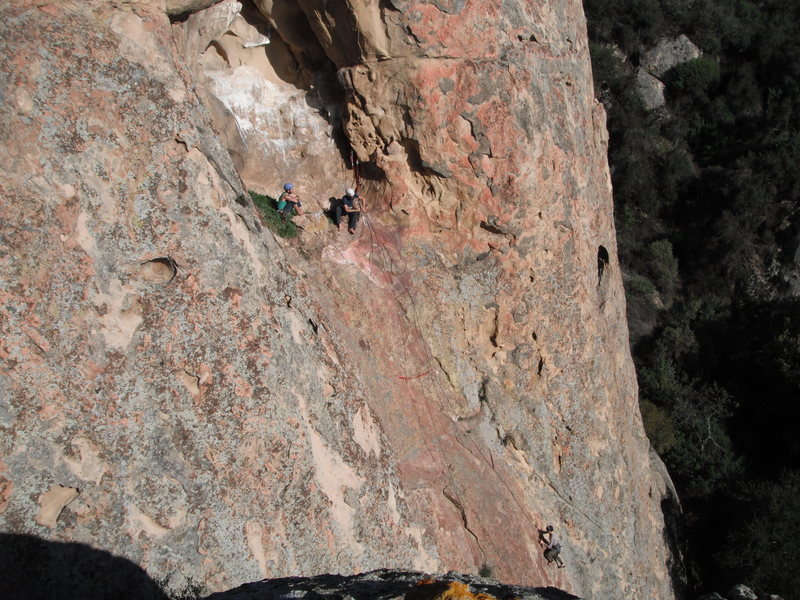 A party of three unknown climbers at the first belay of the Cave Route.