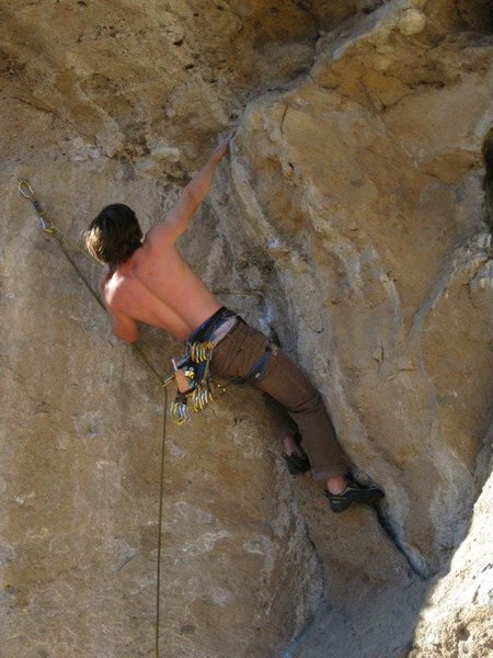 Right hand on a good smaller jug hold. About to use the two finger pocket to come out to the huge pocket.