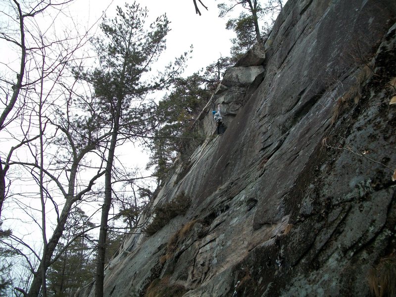 Jon reaching for the big holds on the first ascent.