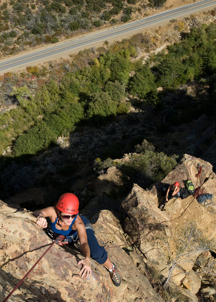 Amy nears the top of the summit block on Spontaneous Order, at the Fortress.