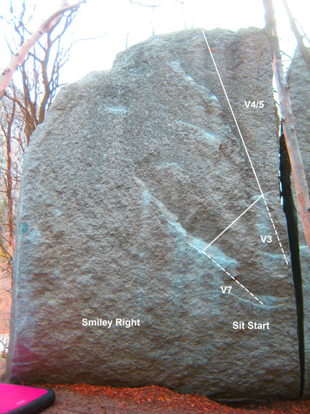 Mr Smiley Right V4/5. Start on the good edge with the left and the sloper with the right. High step, and make a long move up and right. Head straight up on jugs. Using the offwidth to gain the initial jug is V3. Sit start is V7. 