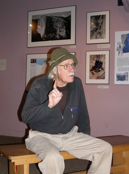 Al Steck sitting in the Yosemite climbing 'museum' display area, with photos in back.