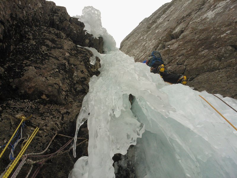 The steep start to the second pitch. The array of 5 pitons and several yards of cord is the anchor at the top of P1.<br>
<br>
Photo by Clay