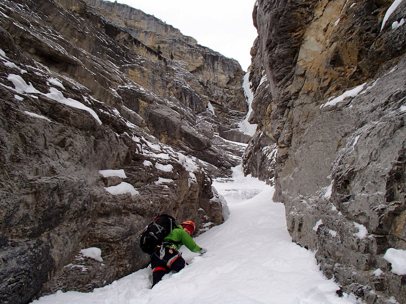 Wading through deep snow in the approach gully.