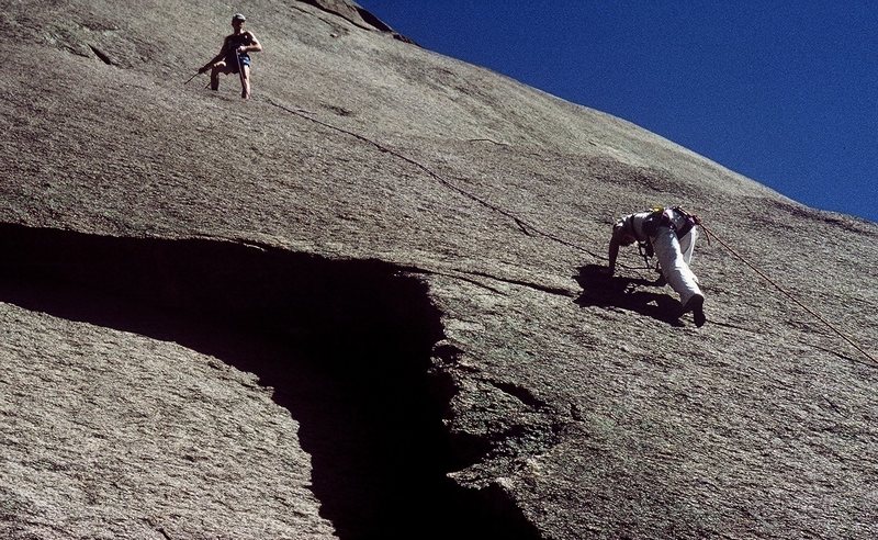 Anne climbing and Gary belaying.