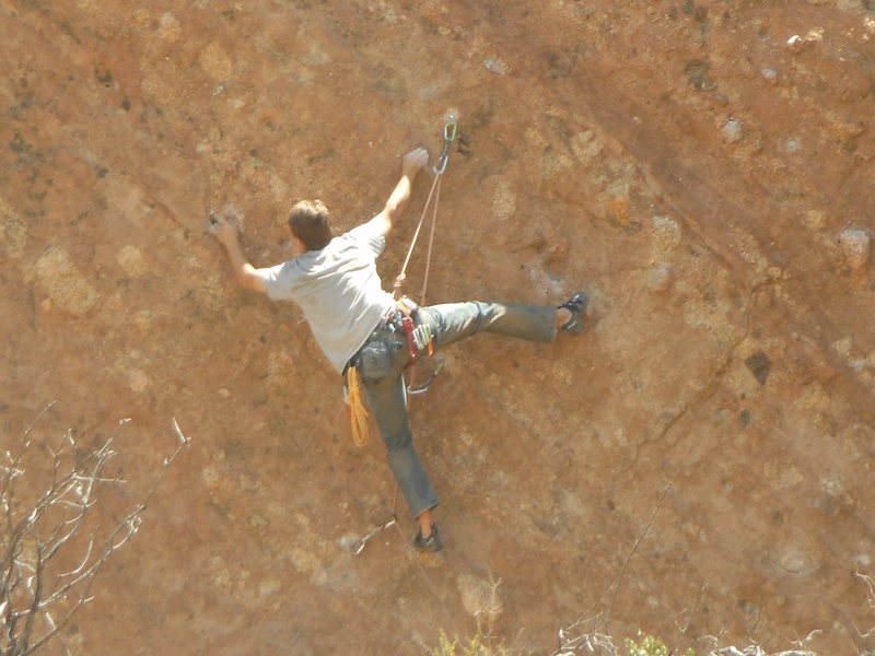 A climber working the moves of a 5.11+ route on the east side of the north end of Corvus Crack.