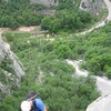 Marin rappelling down Thirsty Dragon, an excellent, 2 pitch route on the Astronaut Wall to the right of the route Sofia. Down below the road, parking area and alpine hut can be seen.