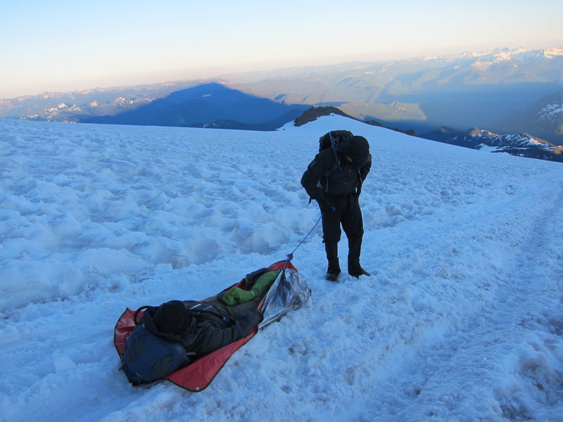 Anthony Vito Fiore Towing climber with severe leg cramps down Mount Rainier glacier as night fall sets.