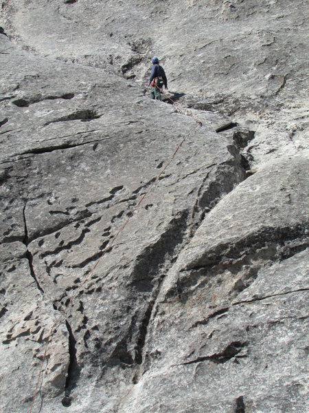 Climber at the common belay point for Cowboy, Cowgirl, and Easy Way Up routes.