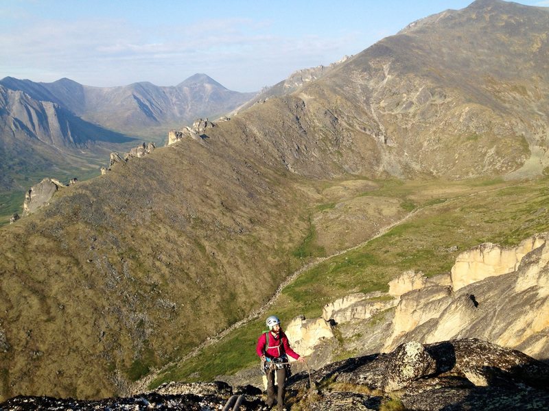 Adrienne Kentner topping out on Ghirardelli with the impressive-looking Lichen Wall in the left background