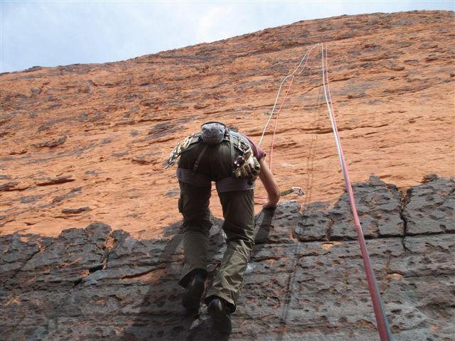 Cleaning the route....shows the varnish-y start to the first bolt.<br>
Can be done in a single pitch with doubles.