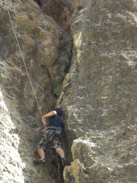 Climber looking up a crux bulge