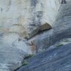 Set up the first belay below the orange lichen, below the overhang alcove where you see the climber. You can see the 2nd belay ledge in upper right corner.