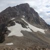 The upper couloir can be reached from a trail that goes up the south ridge from the saddle (lower left part of photo), or by cutting the corner and going up the snowfield/talus (lower right part of photo).