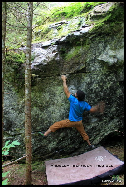  The Bermuda Triangle also known as the Devils Triangle<br>
Begin with big foot holds and two large under clings and move up through the Bermuda Triangle Hold to a reachy crimp.  Continue left to a jug and top it out.  