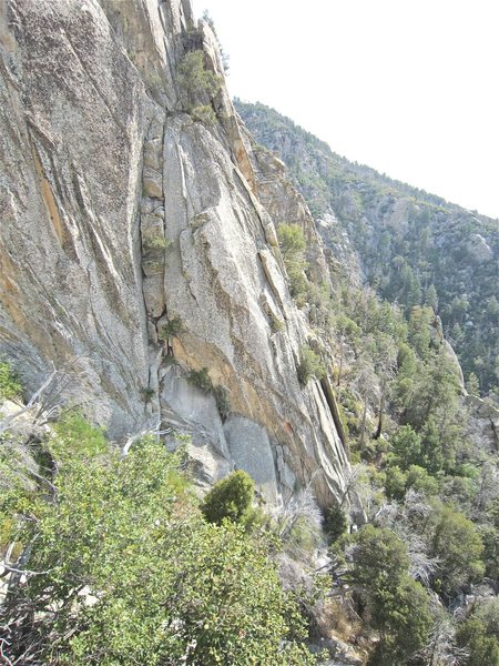 From a distance if you come up hill a little from the toe of the wall you can see the block pile right of the slab. The slab has an arete on the right edge.