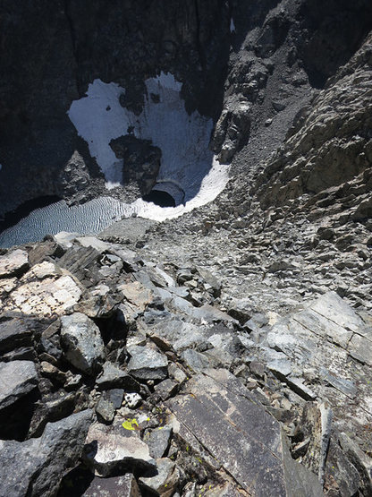 The descent route. This is a little after the first rappel (first rappel is from some black webbing). Following the ridge down the gully. DO NOT GO ALL THE WAY TO THE WATER. You turn left into another gully that will eventually take you to the base of the Normal Start. There is one more rappel waiting in the gully.  