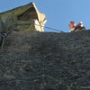 The dicey step-around to a spacious belay.