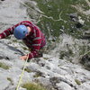 Climbing the marvelous slab pitch at 5.4 and 5.5 for 100 feet. The ruins below are of a First World War Lazarett, or Military Hospital.