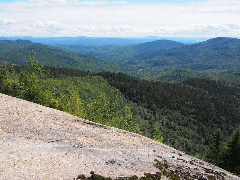 View to the So. East including Albany Covered Bridge on the Swift River, shows you've reached the slab 25ft above the climber's path down to the rap station(s).