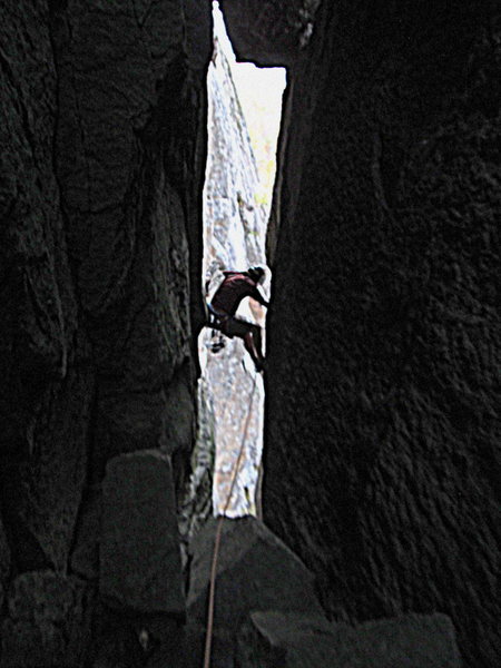 Climbing up the neck of the chimney to the "window" for a nice view of Cascade Lakes