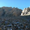 Looking up easy talus field to start of climb.  Pitch 1 starts in the left of the two prominent large cracks that are near the top of the talus field. 