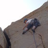 Placing the final pro on the crux pitch.