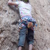 A climber cruxing on "Before the Storm."