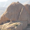 A climber on the east face of The Chicken.