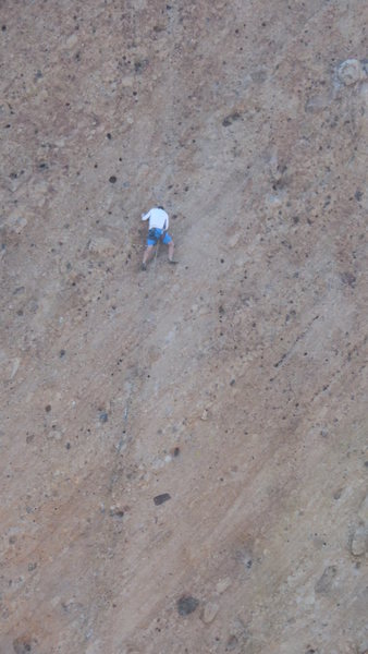 Climber leading on the East Face of The Chicken.