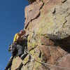 Placing gear to protect the traverse up and left to the fourth bolt.  Seen from the Falcon's Fracture belay pod.<br>
<br>
Photo by Mike Walley.