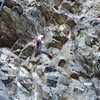 Amber nearing the 1st-pitch crux of "Astro Devil".