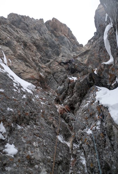 Pitch 3. Looking up the corner system at JD tackling the crux roof.