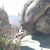 At the summit, find these two boulders.  The left one will be marked with a distinct diagonal crack.  Head between them.