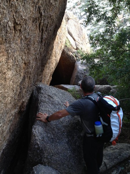 From the base of the climb, looking down the tunnel between the boulders used in the approach.