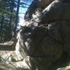 Hard to see a small juniper in the rock, but a large foothold is reached to end the difficulties. 