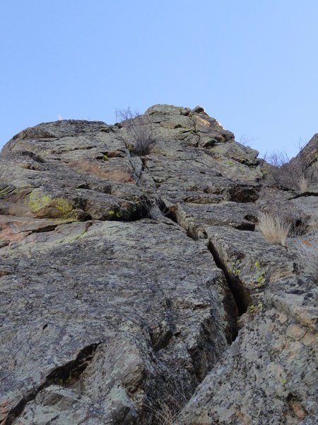 The route follows the obvious crack before traversing right and topping out via the upper crack.