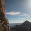 The upper East ridge of Dallas, just prior to the vertical summit block. Sneffels in the back. Jon Fike fourth-classing.