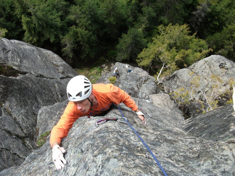 Martin following Right On 5.10d. Rainshadow Crack can be seen in the background before it received a good pruning and scrubbing