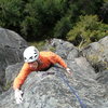 Martin following Right On 5.10d. Rainshadow Crack can be seen in the background before it received a good pruning and scrubbing