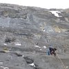 Dave Rone on P3 traverse, heading for the ice up to the right.