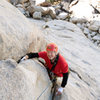 Michael McKay gains the security of the crack after pulling the slabby crux of P1 of Right On, on Saddle Rocks.