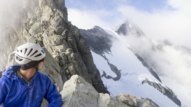 Scott Sampietro relaxing at the B-F Col bivy site with North Ridge in the background