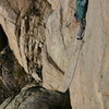 Zach Harrison getting into the crux on pitch 3 (rebolted) (Photo by Zach King)