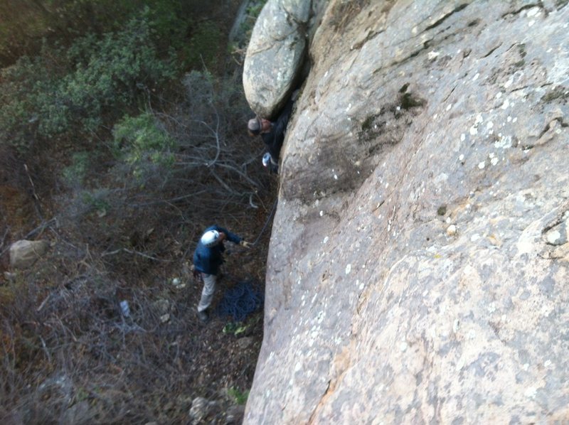<em>Pulling the starting roof on the first ascent.</em>