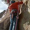 My 8 year old son exiting the chimney at the top of pitch 3. We used the first ledge with the tree as belay #3 instead of continuing up to the next ledge. #4 goes up to the next ledge and go across to the buttress and just left. protect that swing as much as possible if you choose to use the tree instead. Fun!